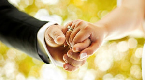 Just married couple, holding hands and walking in nature